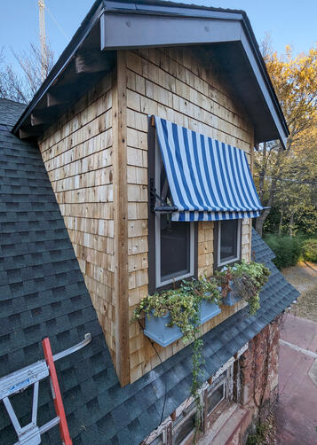 New cedar shakes installed on the dormers of a friend's early century stone barn in NE Oklahoma City. (2023)