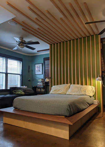 The walnut and baltic birch platform bed, European beech feature wall, and hidden double-sided roll-out closet I built to make my studio apartment more functional for my girlfriend and myself. (2022)