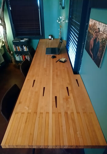 An eleven-foot-long floating desk I built for my studio apartment out of a section of reclaimed bowling alley lane from historic Route 66 Bowl in Oklahoma City. (2021)
