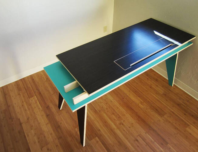 Modern plywood desk for a friend's design firm. I built four matching desks for them, each painted a different bold color on the inside faces. Besides internal storage below the desktop, the inset panel could be removed to access cable management. (2012)